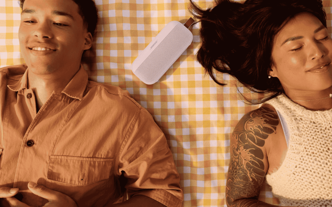Couple enjoying their portable speakers outdoors